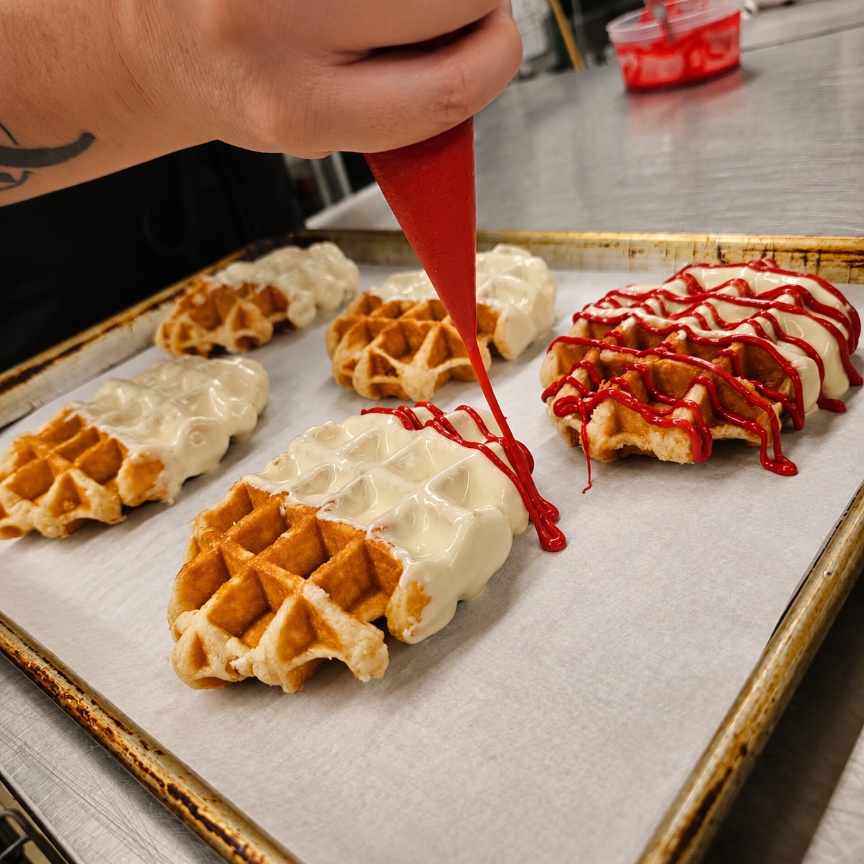 Decorated waffles being finished in the bakery